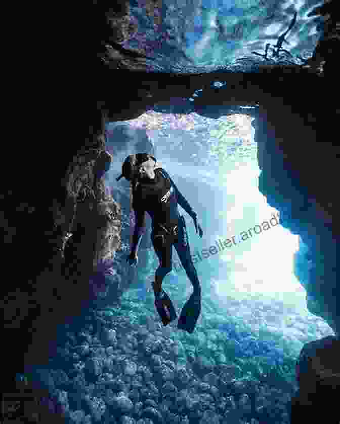 Freediver Exploring An Underwater Cave, Showcasing The Beauty Of Freediving Glass And Water: The Essential Guide To Freediving For Underwater Photography (Dived Up Guides)