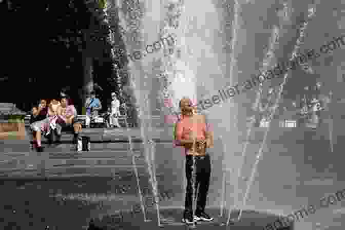 People Seeking Cooling In A Public Fountain During A Heatwave Drought Flood Fire: How Climate Change Contributes To Catastrophes